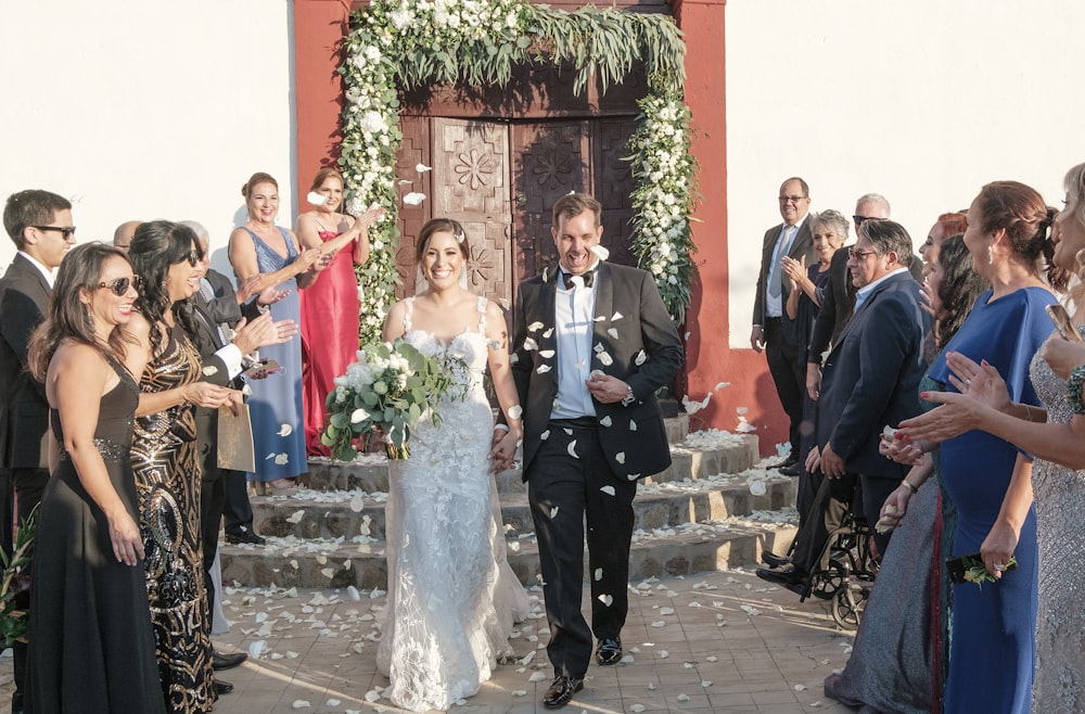 a bride and groom walking down the aisle