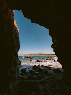 a view of the ocean through a cave