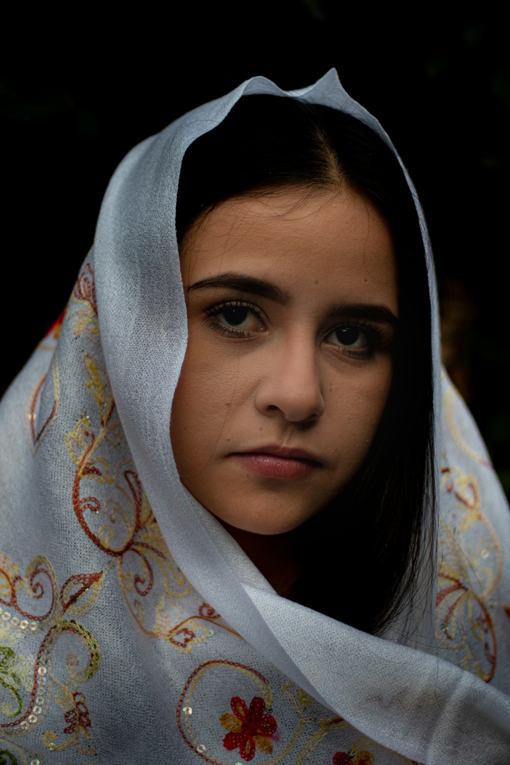 a woman with a white scarf around her head