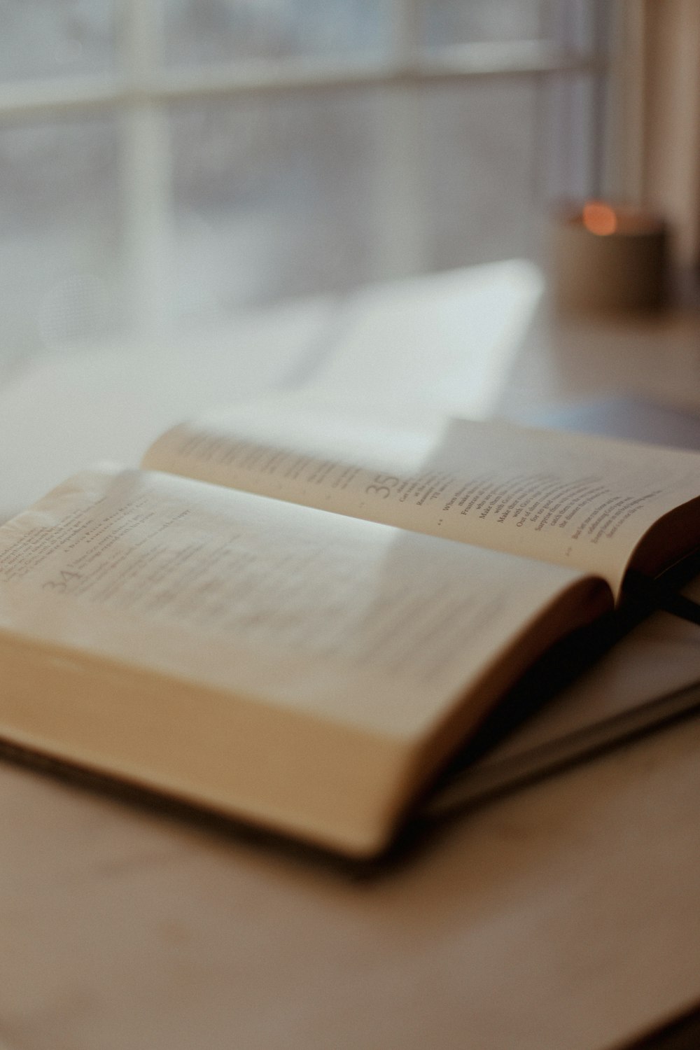 an open book sitting on top of a wooden table