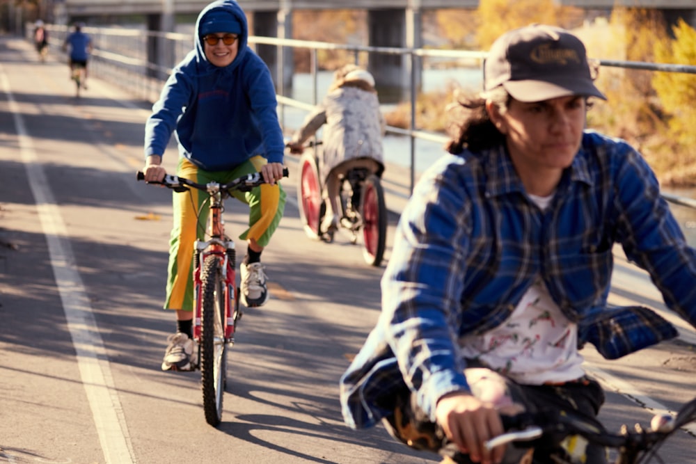 a group of people riding bikes down a street