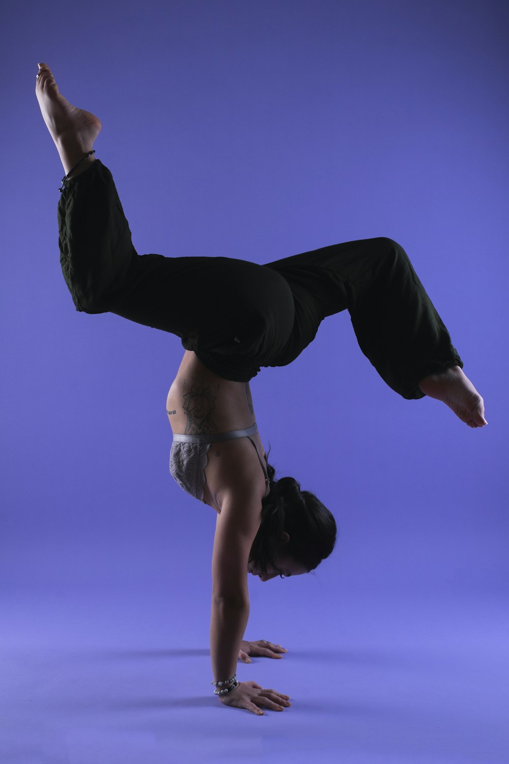 a person doing a handstand on a blue background