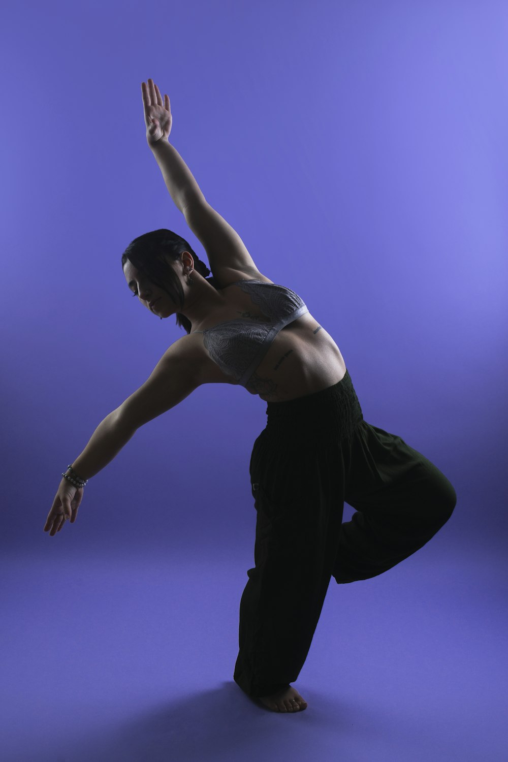 a woman doing a hand stand on one leg