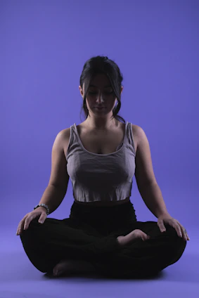 A calm person meditating with soft light highlighting their energy centers.