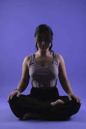 Close-up of a person meditating with soft morning light highlighting calm focus.