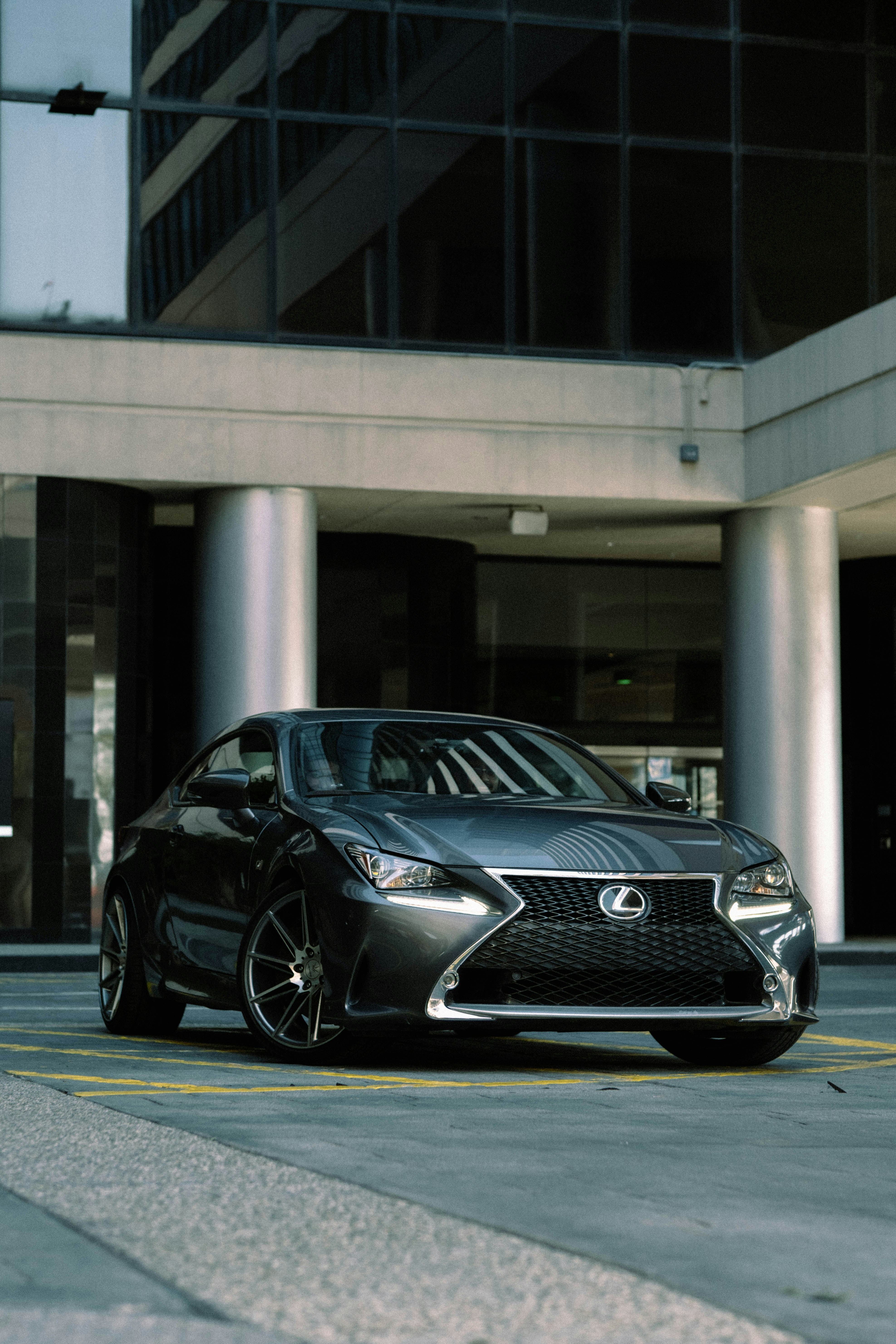 a black car parked in front of a tall building