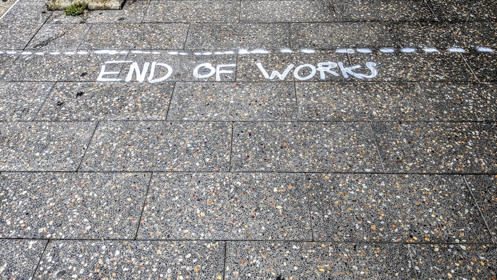 a street sign that reads end of work