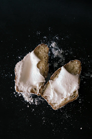 two pieces of bread with white powder on them