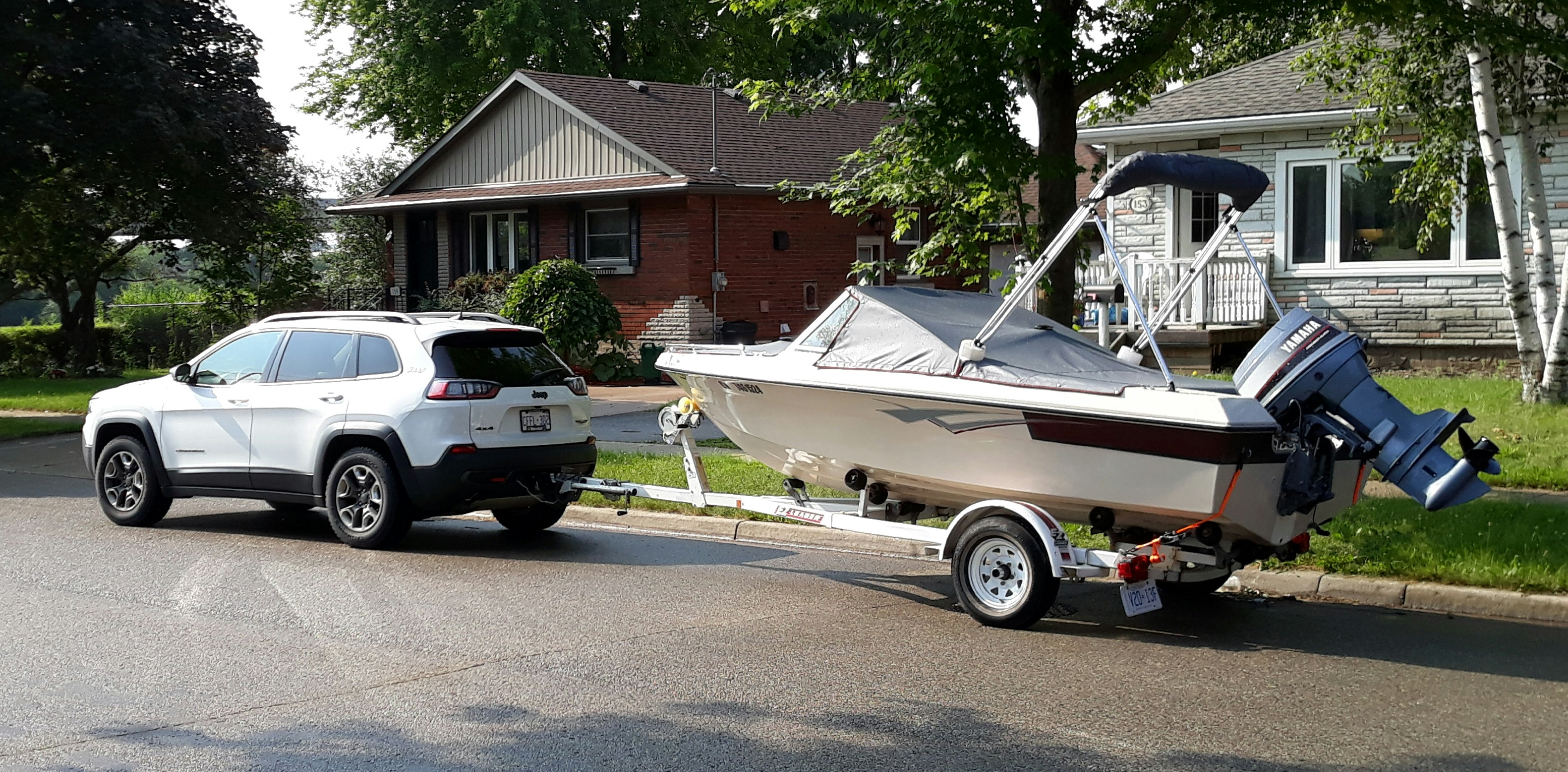 a car pulling a boat on a trailer