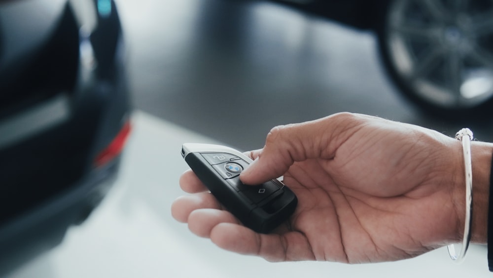 a person holding a cell phone in their hand