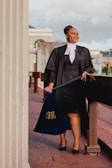 a woman in a black dress holding a blue bag