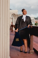 a woman in a black dress holding a blue bag