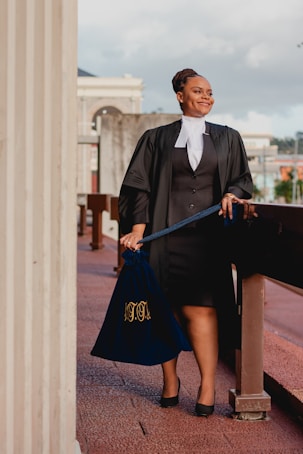 a woman in a black dress holding a blue bag
