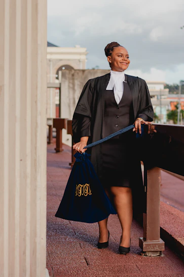 a woman in a black dress holding a blue bag