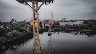 The ropeway gliding above Odhni Dam, framed by rolling hills and calm waters.