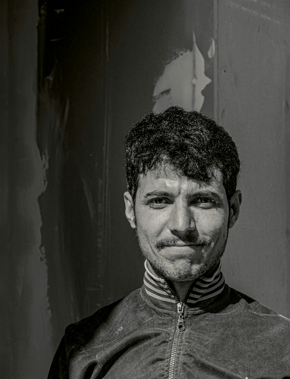 a black and white photo of a man with a goatee