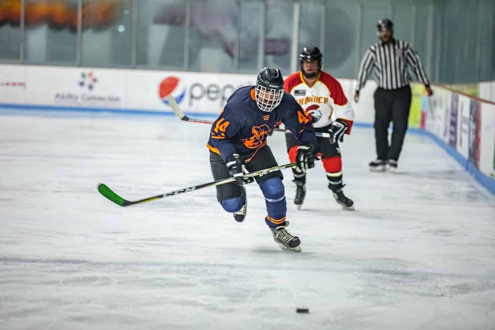 a group of people playing a game of ice hockey