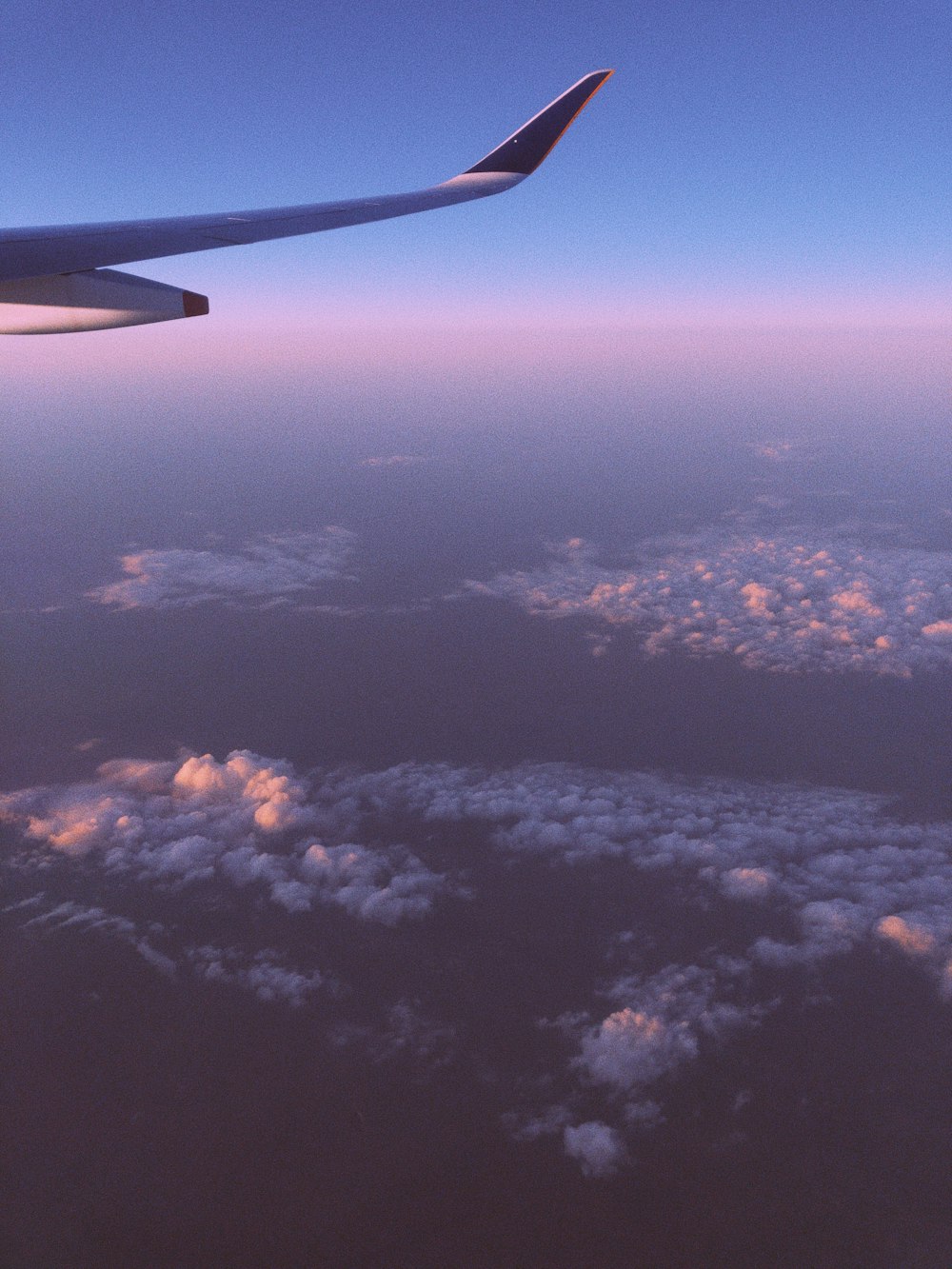 a view of the wing of an airplane in the sky