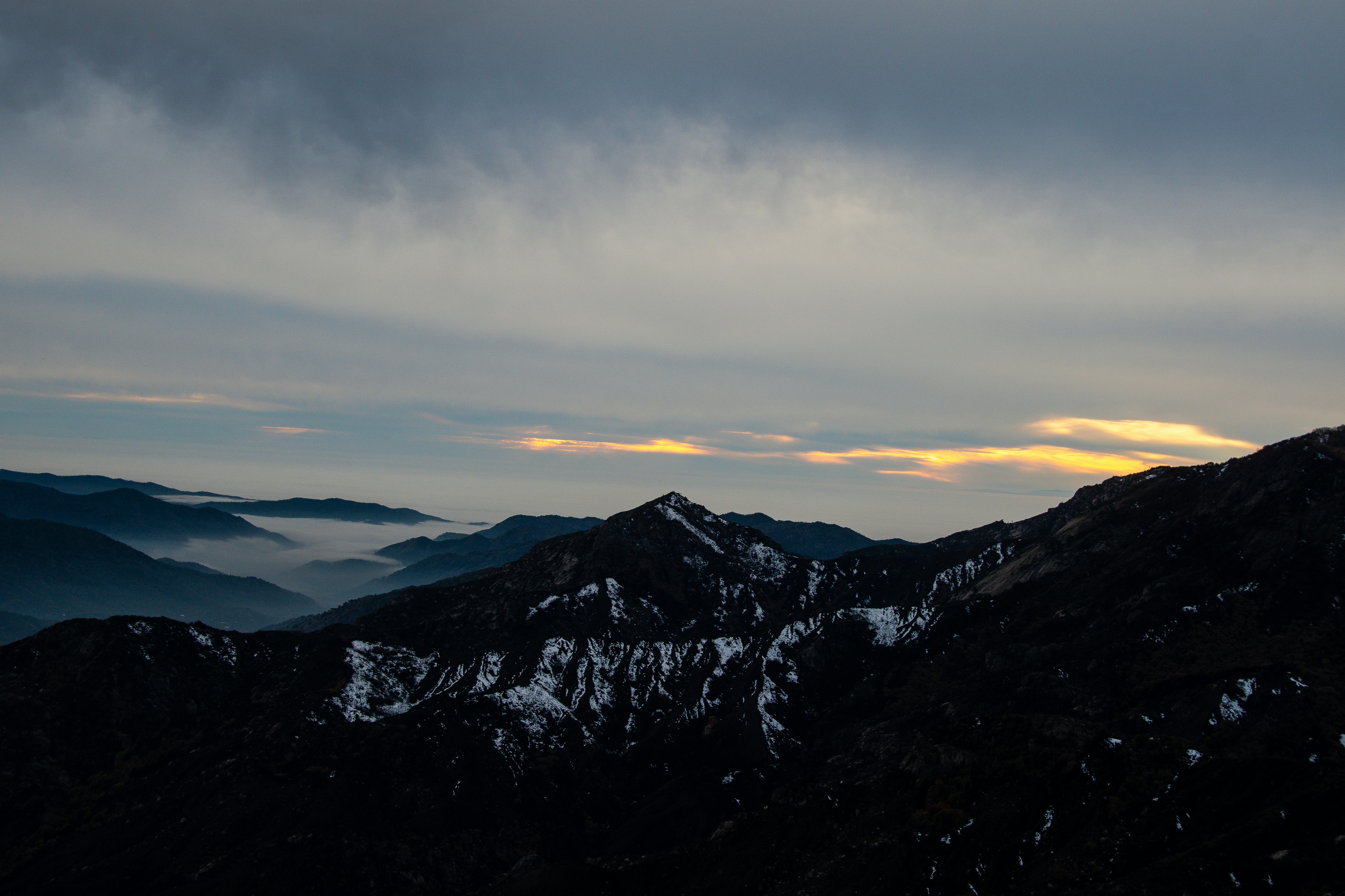 Hikers at sunrise along a mountain ridge