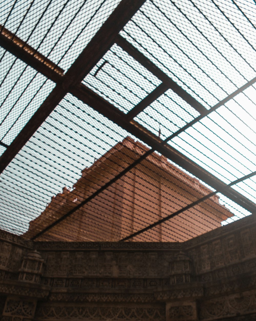 a view of a building through a glass roof