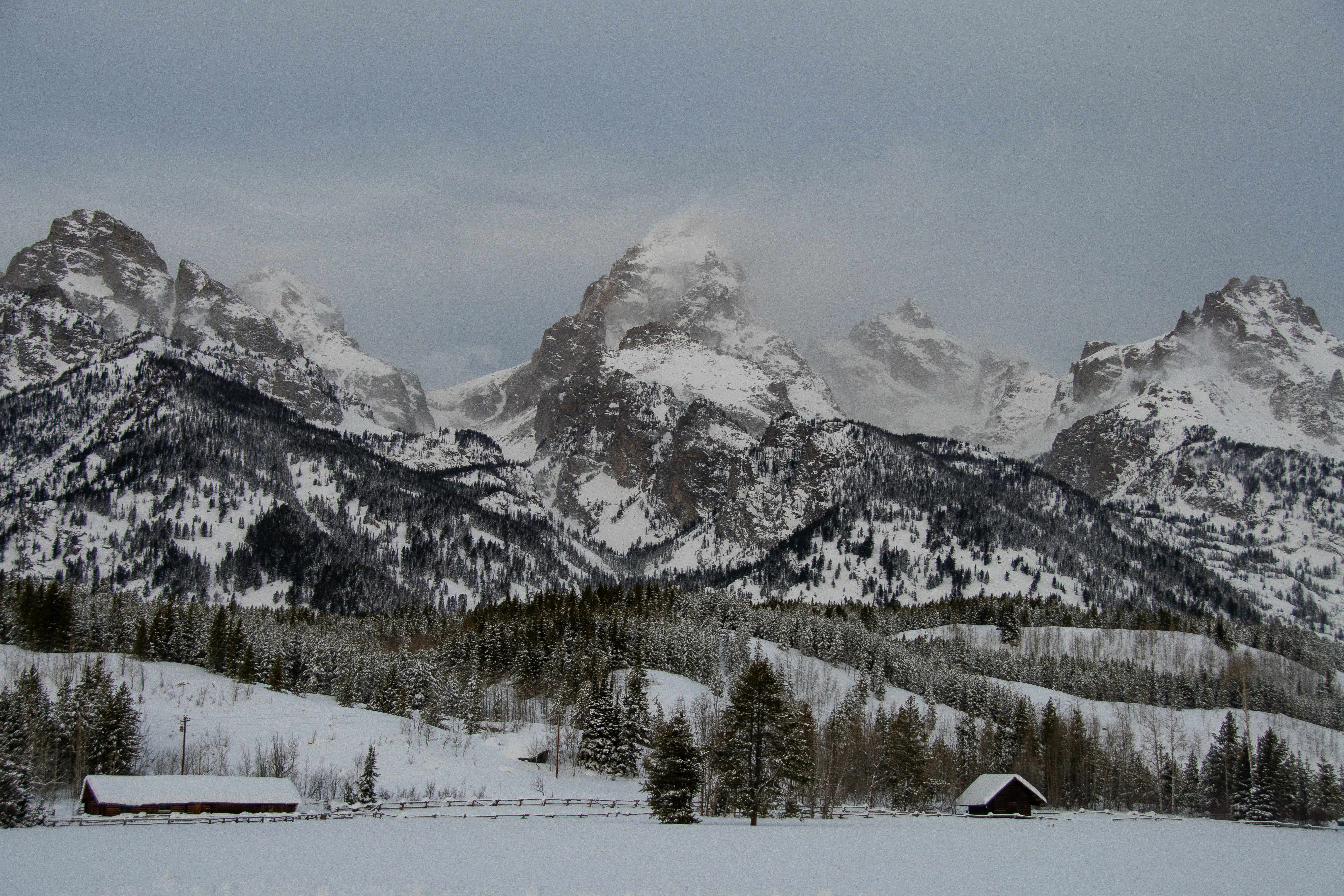 a man standing on top of a snow covered mountain