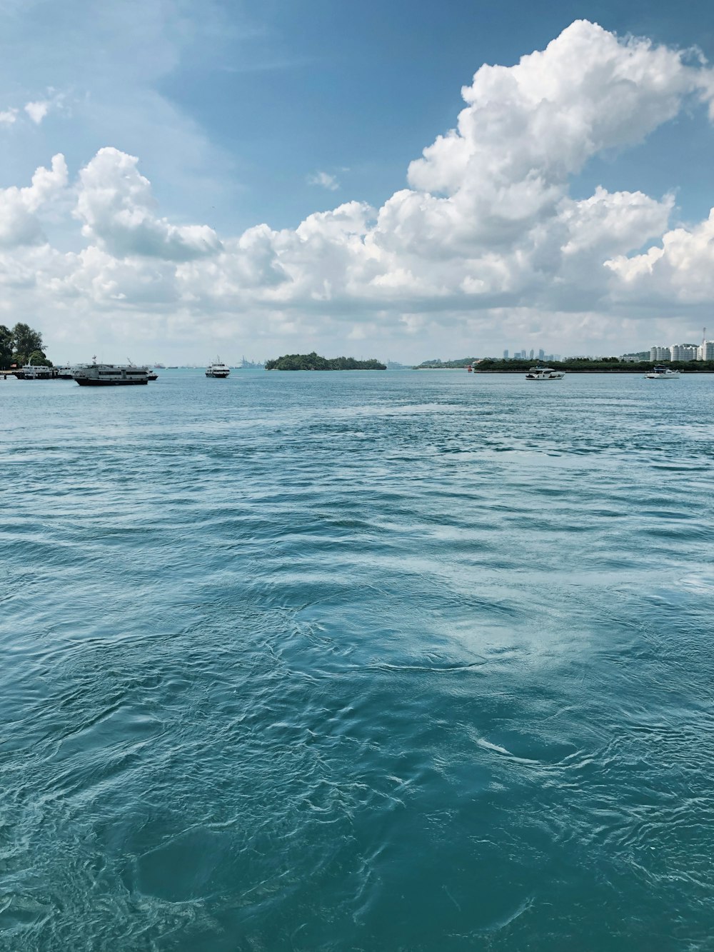 a body of water with boats in the distance