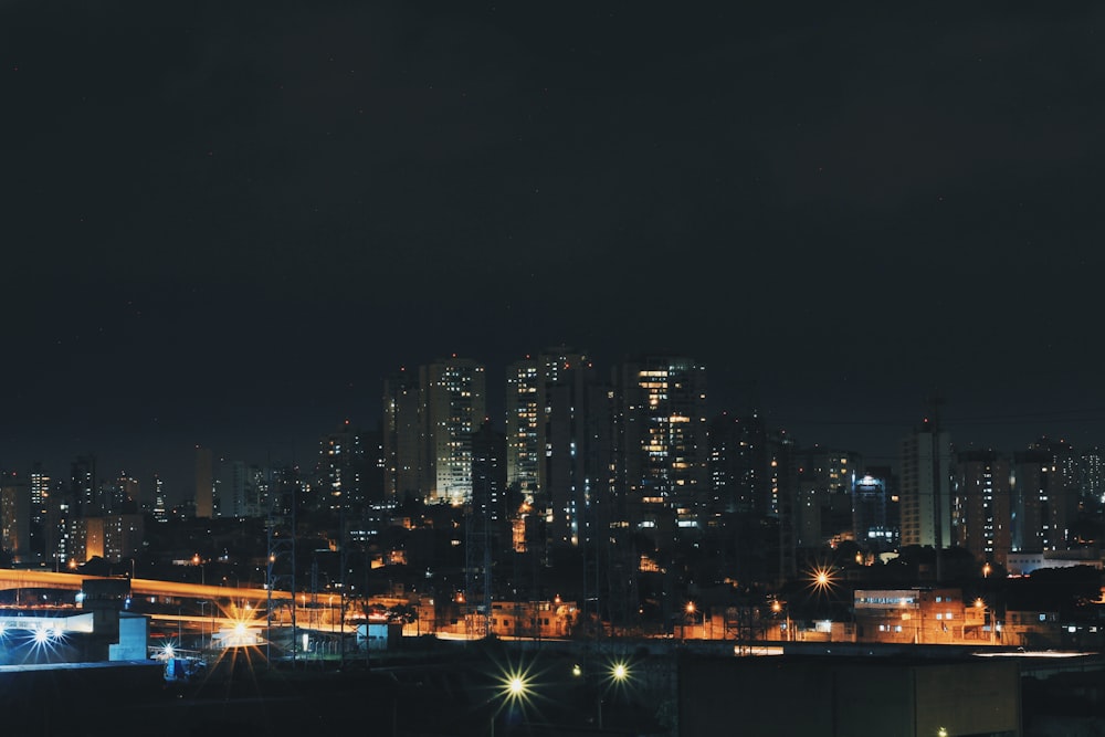 a night view of a city with tall buildings