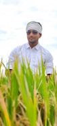A farmer inspecting crops with insurance documents in hand.