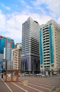 a parking lot in front of some tall buildings