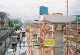 a city street filled with traffic next to tall buildings