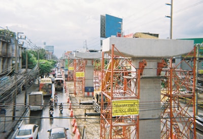 a city street filled with traffic next to tall buildings