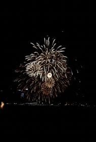 Bright multi-colored fireworks bursting high in the night sky.