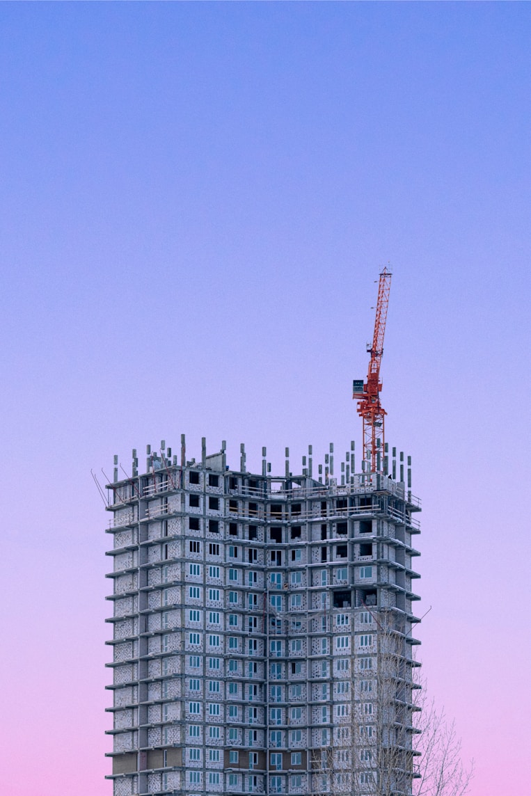 a tall building with a crane on top of it