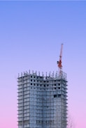 a tall building with a crane on top of it
