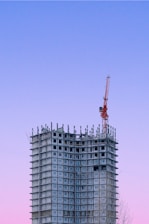 a tall building with a crane on top of it