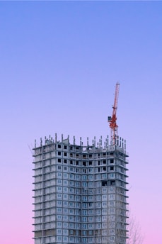 a tall building with a crane on top of it