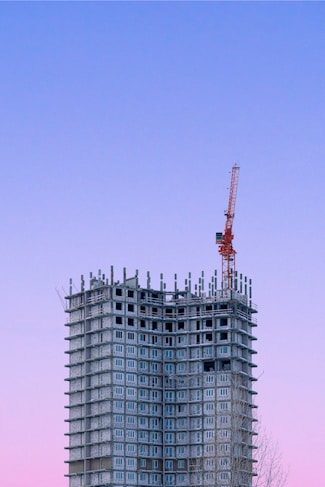 a tall building with a crane on top of it