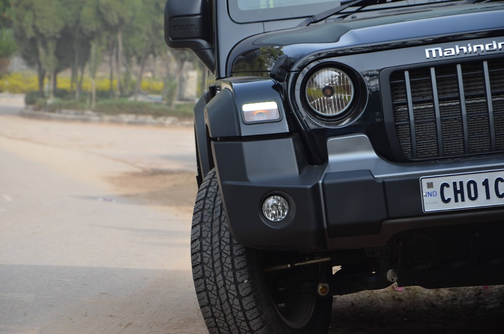 a black jeep parked on the side of a road