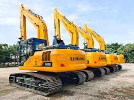 a row of yellow and blue construction machines