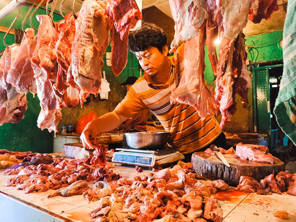 a man in a butcher shop preparing meat