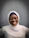Portrait of a smiling young Arabic woman with glasses, representing a satisfied customer.