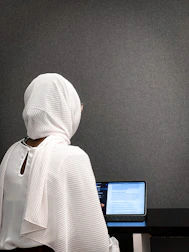 A calm workspace with a user engaging with the app’s daily Islamic reminders on a tablet.