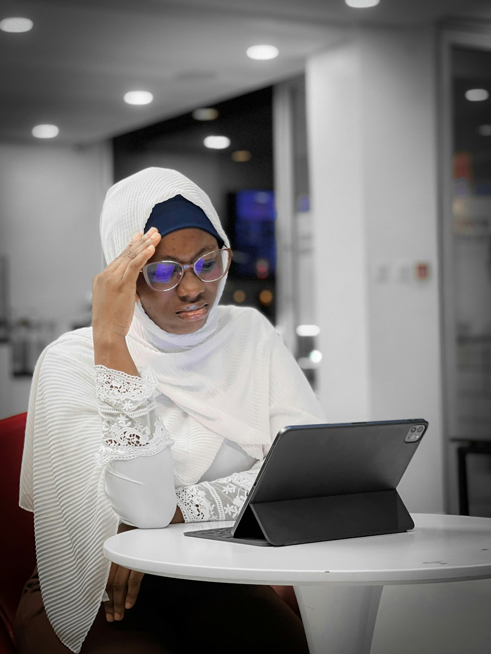 a woman sitting at a table with a laptop