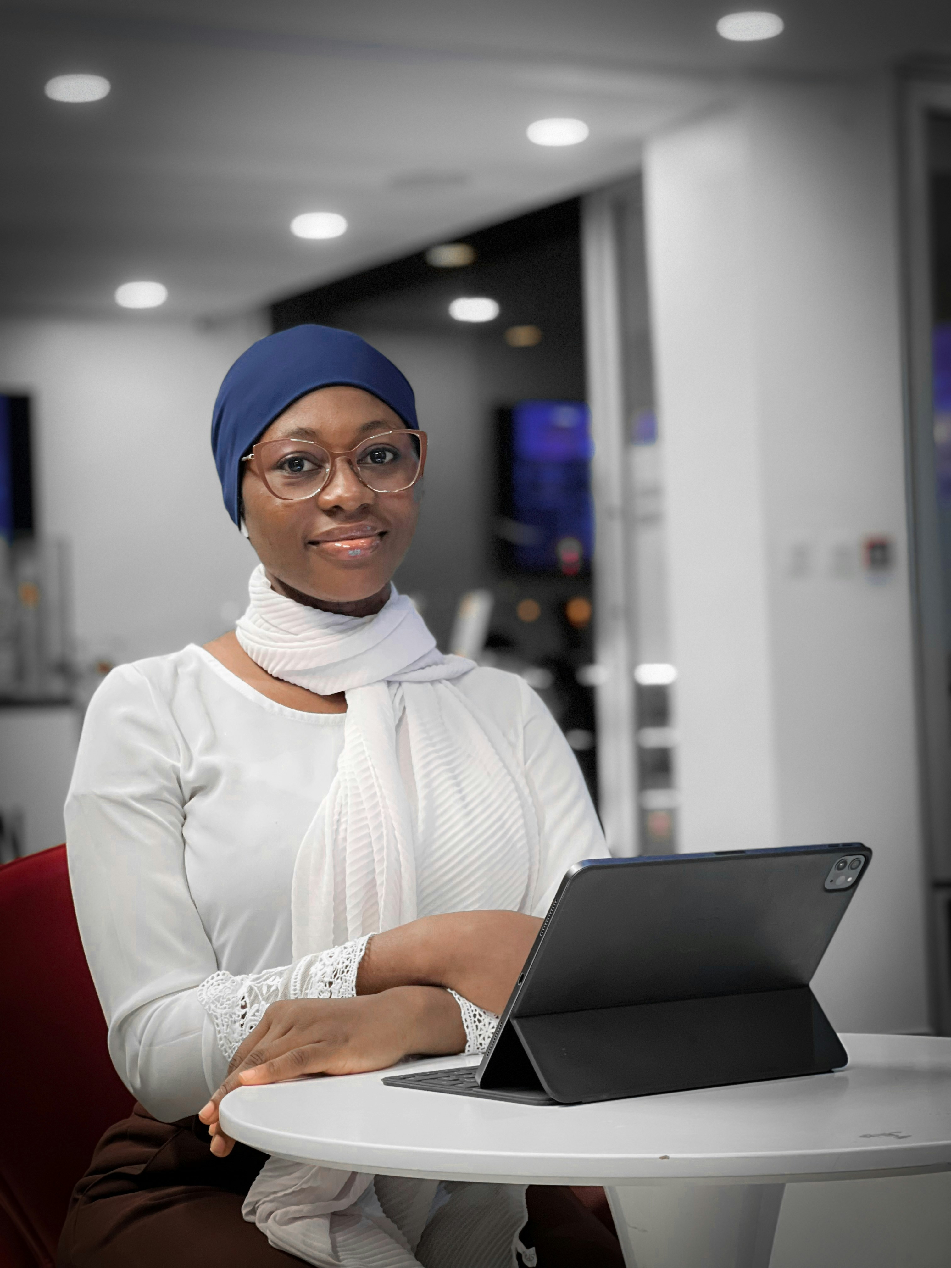 a woman sitting at a table with a laptop