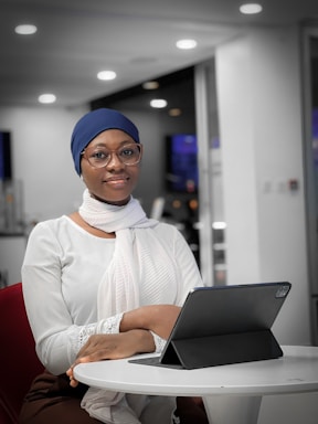 a woman sitting at a table with a laptop