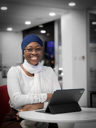 a woman sitting at a table with a laptop