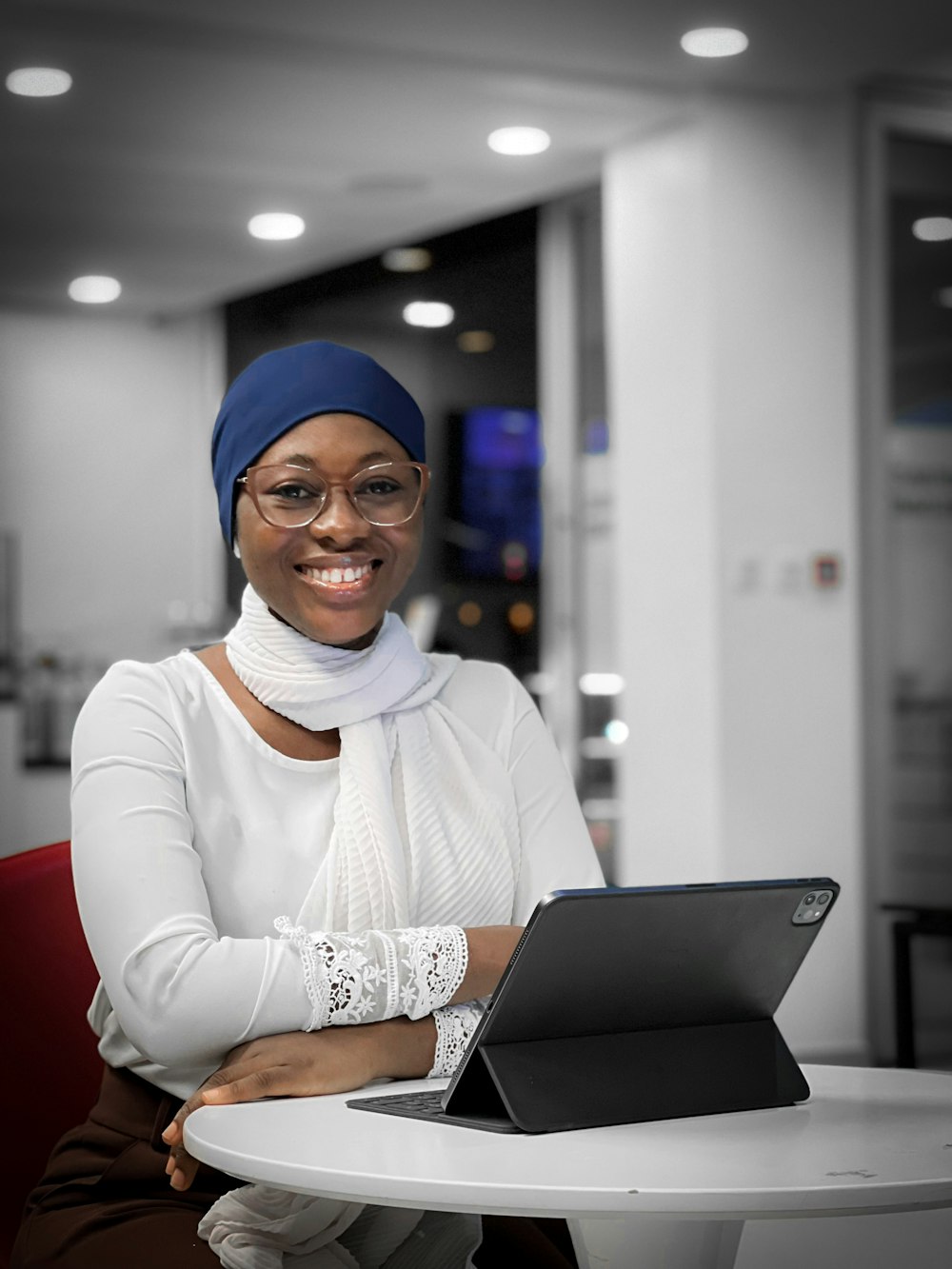 a woman sitting at a table with a laptop