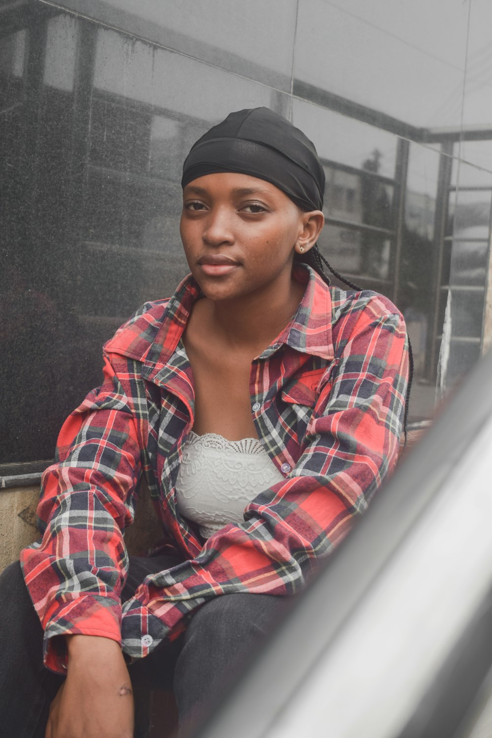 a woman sitting on the side of a bus