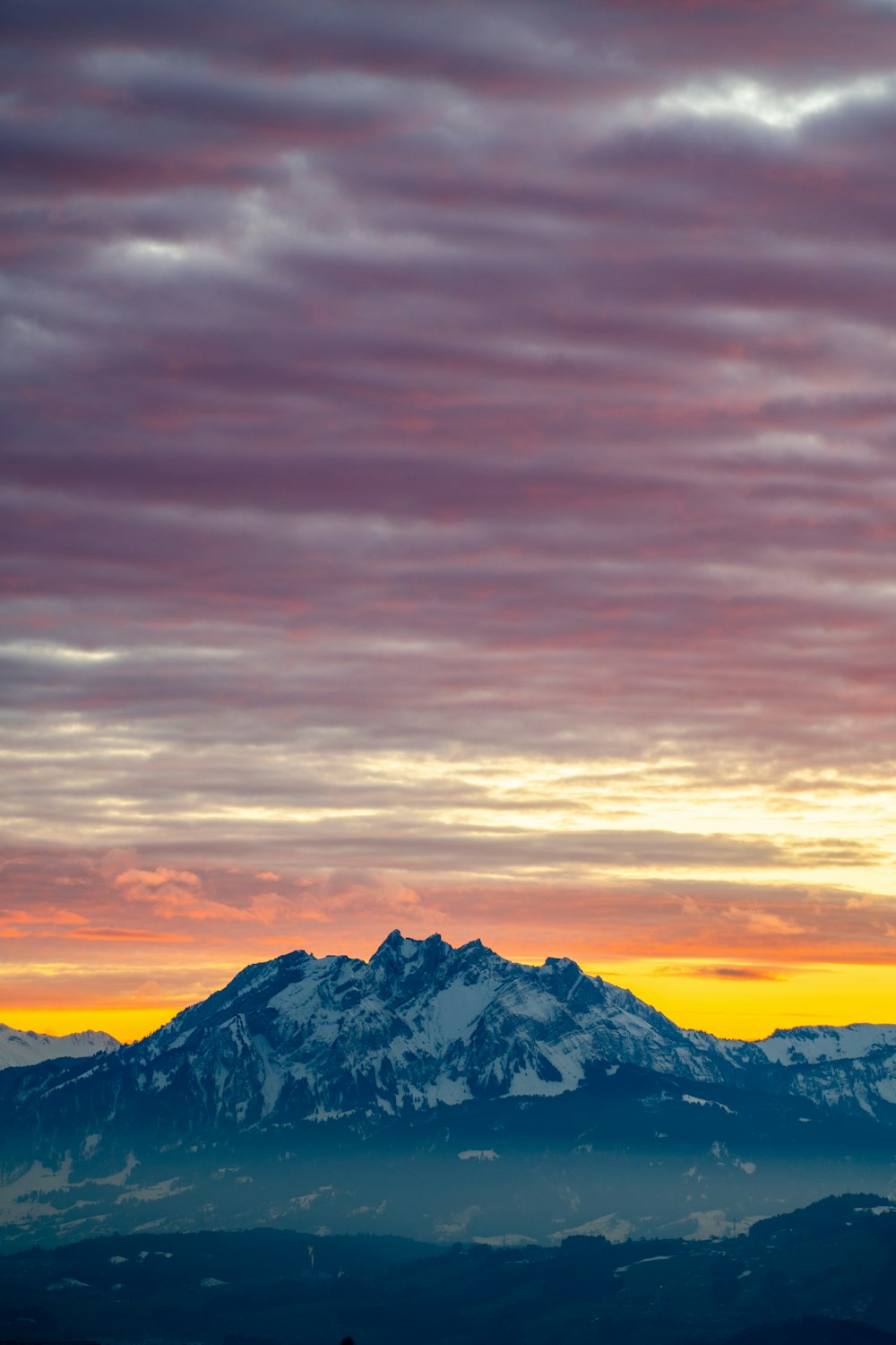 a mountain with clouds around it