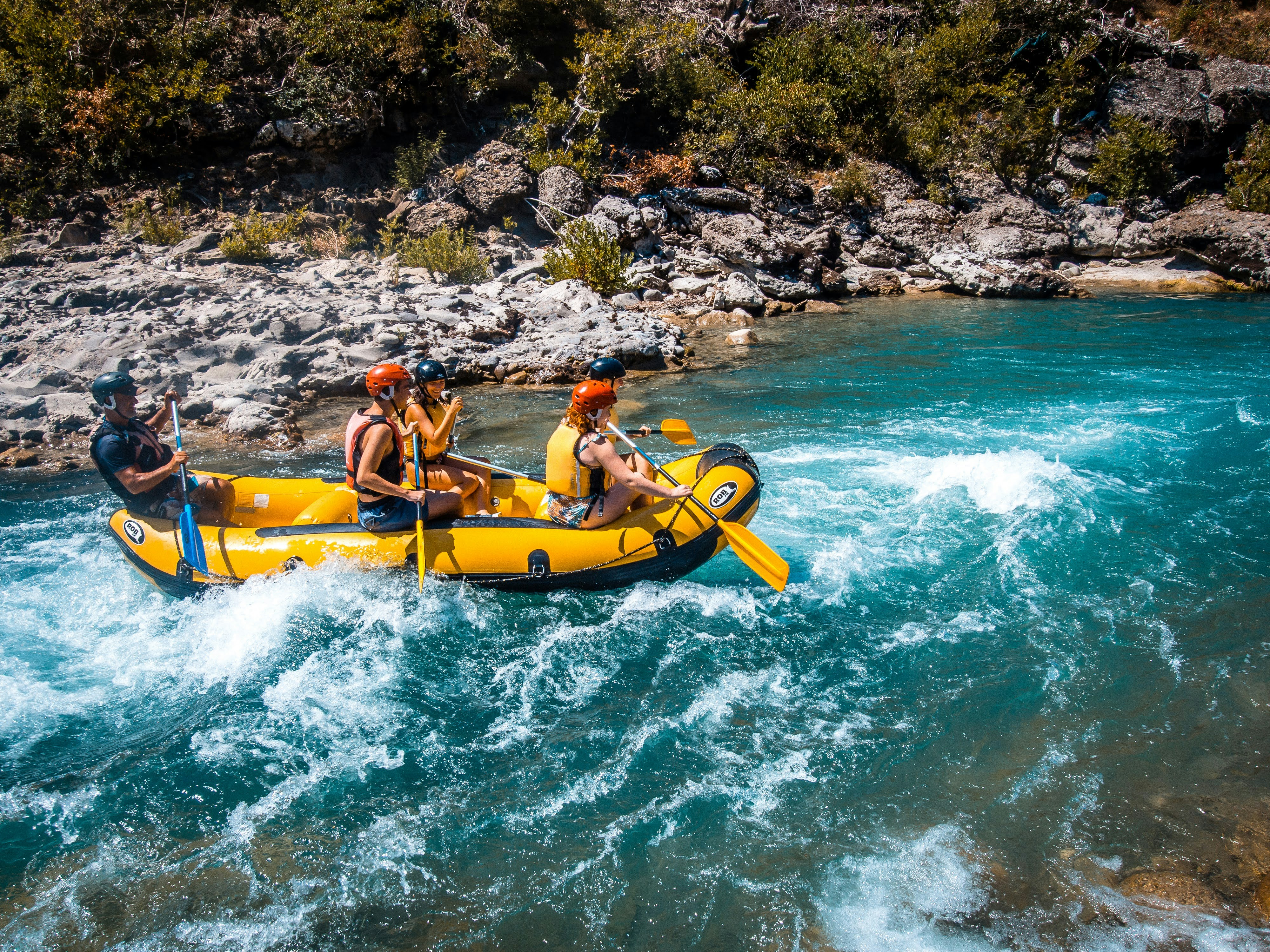 a group of people riding on the back of a raft